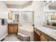 Primary bath featuring soaking tub, marble countertops, dual sinks, and a block glass window at 12705 Kalamath Ct, Westminster, CO 80234