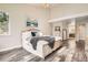 Bedroom with wood-look floors, king bed, neutral walls and decor, and connected bathroom at 12705 Kalamath Ct, Westminster, CO 80234