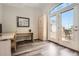 Home office featuring wood-look floors, desk, ample storage, and access to outdoor patio seating at 12705 Kalamath Ct, Westminster, CO 80234