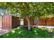 Shaded backyard with a shed, mature tree, and a swing, perfect for outdoor relaxation at 5067 S Mabre Ct, Littleton, CO 80123