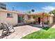 Backyard patio with a covered area, string lights, and landscaped yard with a greenhouse at 5067 S Mabre Ct, Littleton, CO 80123