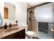 Bathroom featuring a granite vanity, a frosted glass shower, and modern fixtures at 5067 S Mabre Ct, Littleton, CO 80123
