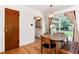 Bright dining room featuring hardwood floors and sliding glass doors to the backyard at 5067 S Mabre Ct, Littleton, CO 80123