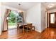 Charming dining area with hardwood floors, slider door, and a modern light fixture at 5067 S Mabre Ct, Littleton, CO 80123