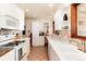 Efficient kitchen featuring white cabinetry, modern appliances, and ample counter space at 5067 S Mabre Ct, Littleton, CO 80123