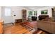 Cozy living room boasts hardwood floors, large windows, and ample space for seating at 5067 S Mabre Ct, Littleton, CO 80123