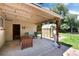 Covered patio with decorative string lights, seating, and view of the well-manicured backyard at 5067 S Mabre Ct, Littleton, CO 80123
