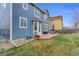 A backyard featuring a patio with outdoor furniture, lawn and the exterior of a two-story home at 17216 E Trailmaster Dr, Parker, CO 80134