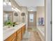 Bright bathroom with double sinks, a bathtub, and a walk-in shower at 17216 E Trailmaster Dr, Parker, CO 80134