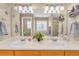 Bathroom featuring double sinks, a large mirror, and decorative lighting at 17216 E Trailmaster Dr, Parker, CO 80134