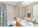 Bathroom featuring a vanity with a sink and a shower/tub with patterned curtains at 17216 E Trailmaster Dr, Parker, CO 80134