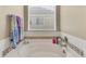 Bright bathroom with a white bathtub and decorative tile at 17216 E Trailmaster Dr, Parker, CO 80134