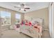 bedroom with a ceiling fan, two windows, and a playful decor at 17216 E Trailmaster Dr, Parker, CO 80134