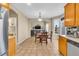 Bright dining room with a wood table and chairs and connecting to a living room area at 17216 E Trailmaster Dr, Parker, CO 80134