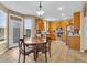 Bright kitchen with oak cabinets, stainless steel appliances, and an adjacent dining area at 17216 E Trailmaster Dr, Parker, CO 80134