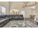 Bright living room with a view of the kitchen, hardwood floors, and comfortable leather sofas at 17216 E Trailmaster Dr, Parker, CO 80134