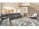 Open-concept living room with a staircase, wood floors, and comfortable seating at 17216 E Trailmaster Dr, Parker, CO 80134