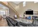 Cozy living room featuring a staircase, entertainment center, and a view of the fireplace at 17216 E Trailmaster Dr, Parker, CO 80134