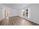 Bright bedroom showcasing new vinyl floors, neutral walls, and natural light from a large window at 5325 Allison St, Arvada, CO 80002