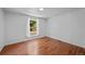 A bright bedroom featuring wood-look flooring and a window offering outdoor views at 5325 Allison St, Arvada, CO 80002