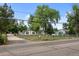Property featuring mature trees and fencing at 5325 Allison St, Arvada, CO 80002