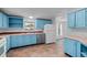 Bright kitchen with blue cabinets and stainless steel appliances at 5325 Allison St, Arvada, CO 80002