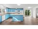 Bright, updated kitchen featuring blue cabinets, a center island, and modern appliances at 5325 Allison St, Arvada, CO 80002