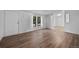 Living room features new vinyl floors, neutral walls, and natural light from a large window at 5325 Allison St, Arvada, CO 80002