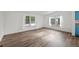 Open living space featuring new floors, and large windows that provide natural light at 5325 Allison St, Arvada, CO 80002