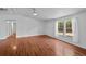 A spacious living room with wood-look flooring, white walls, and a modern ceiling fan at 5325 Allison St, Arvada, CO 80002