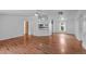 Open-concept living space with wood-look flooring, a ceiling fan, and white walls at 5325 Allison St, Arvada, CO 80002