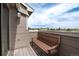 Relaxing balcony features a wooden bench with a nice view of the outdoors and clear skies at 7408 S Alkire St # 301, Littleton, CO 80127