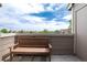 Relaxing balcony features a wooden bench with a nice view of the outdoors and clear skies at 7408 S Alkire St # 301, Littleton, CO 80127