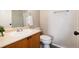 Bathroom features a vanity with white sink and chrome faucet, toilet, and shower behind glass door at 7408 S Alkire St # 301, Littleton, CO 80127