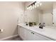 Bathroom featuring double sink vanity, modern fixtures, ample counter space, and modern finishes at 7408 S Alkire St # 301, Littleton, CO 80127