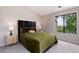 Bedroom featuring plush carpet, a large window with greenery views, and natural light at 7408 S Alkire St # 301, Littleton, CO 80127