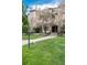 A beautiful exterior view of the home with a well-maintained lawn and blooming trees at 7408 S Alkire St # 301, Littleton, CO 80127