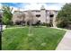 Apartment complex with well-maintained lawn and mature trees at 7408 S Alkire St # 301, Littleton, CO 80127