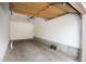 This is an empty garage space with concrete floor and white walls at 7408 S Alkire St # 301, Littleton, CO 80127