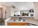Stainless steel sink overlooking an open plan living room with fireplace and outdoor deck at 7408 S Alkire St # 301, Littleton, CO 80127