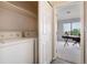 Convenient laundry room leads to a stylish office with natural light and plush carpeting at 7408 S Alkire St # 301, Littleton, CO 80127