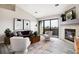 Cozy living room with fireplace, balcony access, and modern decor at 7408 S Alkire St # 301, Littleton, CO 80127