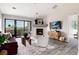 Bright living room featuring a fireplace, balcony access, and stylish decor at 7408 S Alkire St # 301, Littleton, CO 80127