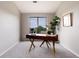Stylish office features a large window, modern desk with gold accents, and plush carpeting at 7408 S Alkire St # 301, Littleton, CO 80127