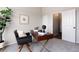 Modern office features a stylish desk, black office chair, and convenient access to the hallway at 7408 S Alkire St # 301, Littleton, CO 80127