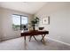 Stylish office features a large window, modern desk with gold accents, and plush carpeting at 7408 S Alkire St # 301, Littleton, CO 80127