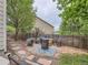 Cozy backyard setting with a stone path, fire pit area, wood fence, and serene landscaping at 8010 Raspberry Dr, Frederick, CO 80504