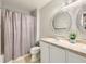 Bathroom with dual sinks, granite countertop, decorative mirrors, and a shower with curtain at 8010 Raspberry Dr, Frederick, CO 80504