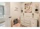 Charming bathroom nook featuring elegant decor, a vanity with storage, and a view of the soaking tub at 8010 Raspberry Dr, Frederick, CO 80504