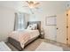 Charming bedroom featuring a plush, tufted headboard, soft textures, and a stylish ceiling fan with light at 8010 Raspberry Dr, Frederick, CO 80504
